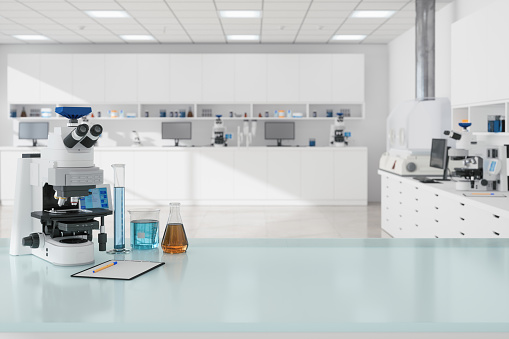 Close-up view Of Microscope And Laboratory Equipments On Empty Desk In Science Laboratory