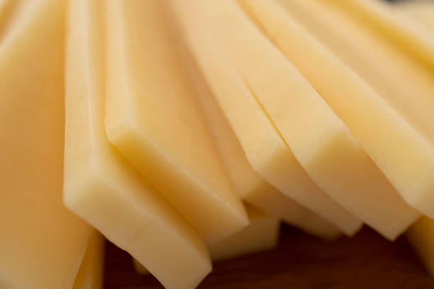 Piece and slices of cheese isolated on white background from top view