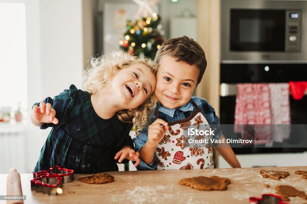 It smells like Christmas! Children making Christmas cookies. Christmas Stock Photo