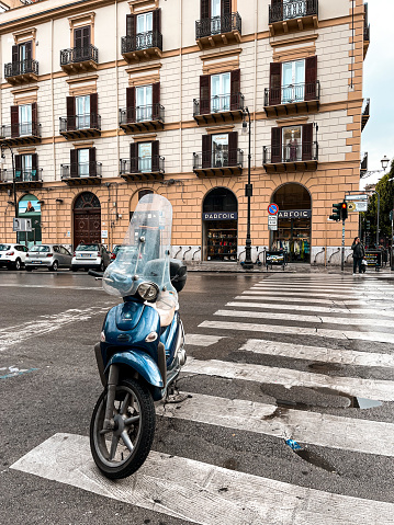 A vespa scooter parked incorrectly in Palermo - exactly on the pedestrian crossing.