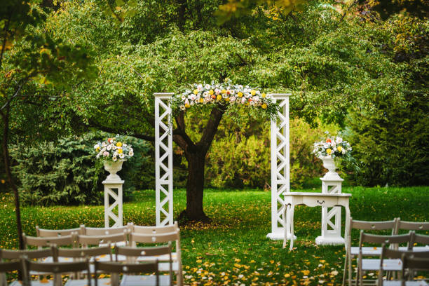 istock Beautiful wedding arch decorated with fresh flowers 1450386406