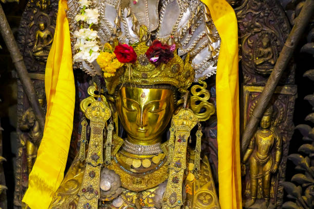 istock Small golden Buddha statue in buddhist temple 1450388205