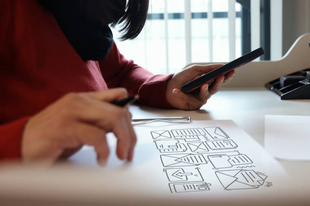 istock Woman using mobile phone with envelope icons 1450389262