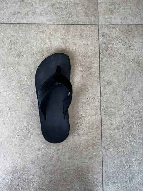 istock Old slippers on concrete background with copy space. 1450389280