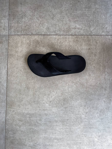 istock Old slippers on concrete background with copy space. 1450389286