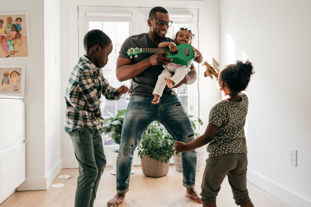istock Dad playing with kids  indoors 1450390534