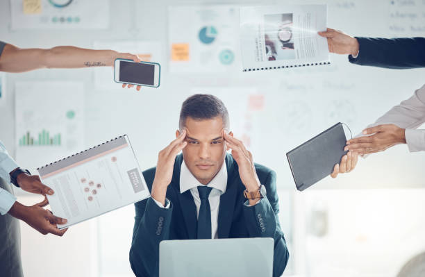 istock Stress, burnout and overworked with a business man suffering from a headache and feeling overwhelmed by multitasking demand. Mental health, frustrated and fail with a stressed male employea at work 1450390801