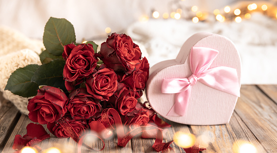 Frame of red roses and heart on pink background. Top view. Copy space. Valentines day concept