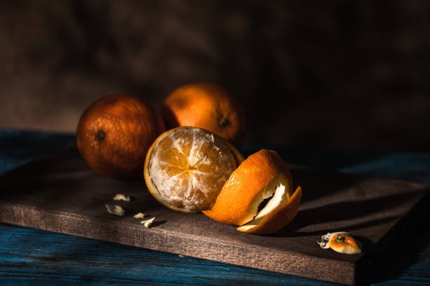 Peeled orange on a dark wooden table.