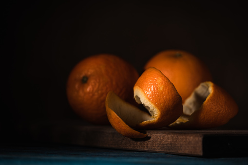 Dark table with oranges.