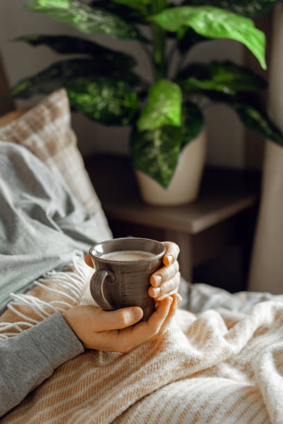istock a caucasian man relaxing at home, drinking coffee in bed 1450393284