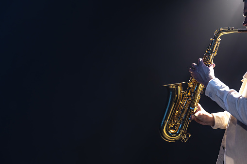 Man playing a saxophone and a drummer performing isolated on white background