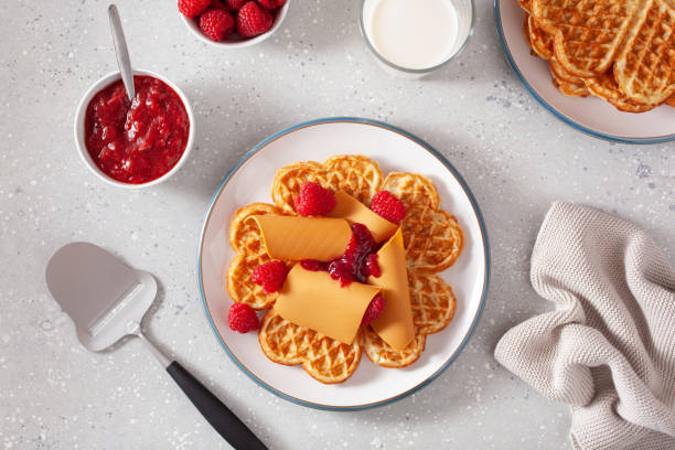 istock waffles with Norwegian brunost traditional brown cheese and raspberry jam 1450395132