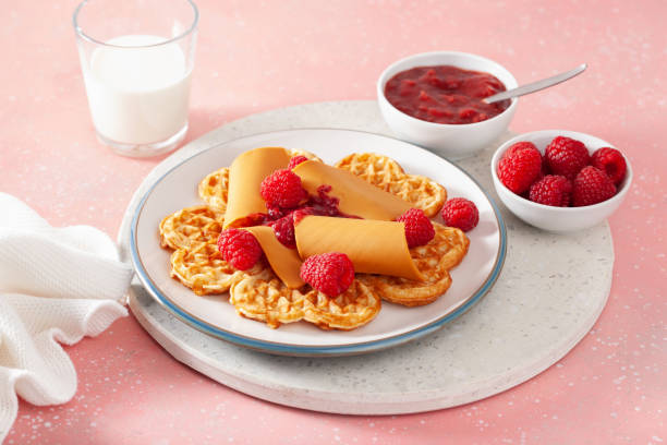 istock waffles with Norwegian brunost traditional brown cheese and raspberry jam 1450395183