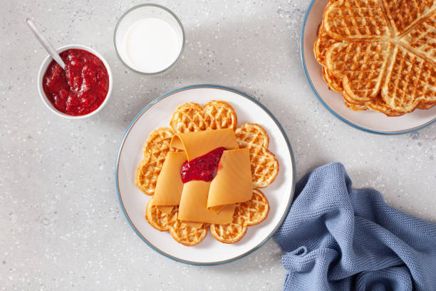 istock waffles with Norwegian brunost traditional brown cheese and raspberry jam 1450395252