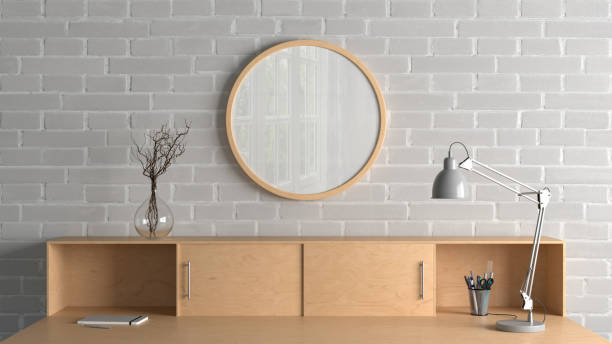 istock Wooden round poster frame mock up on the brick wall of home studio workspace. Front view. 1450397589