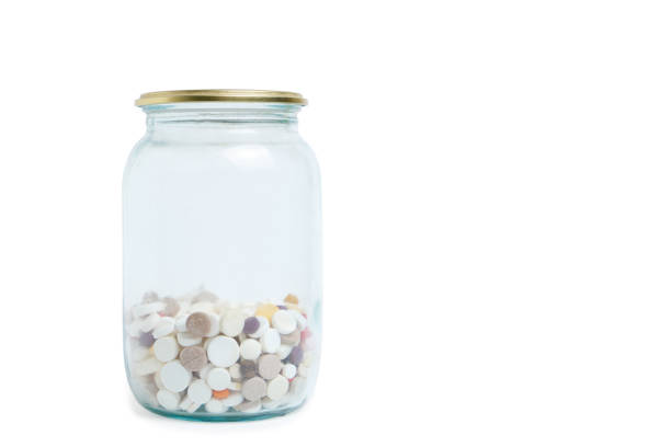 istock Glass jar with pills, on a white background. Stock medicines. 1450399045