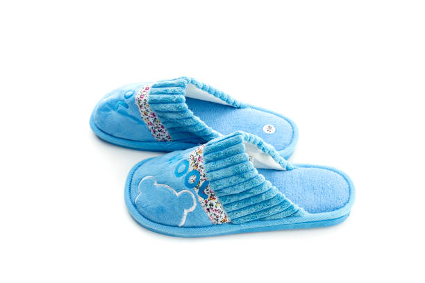 New, beautiful, warm, blue, female slippers on a white background close-up