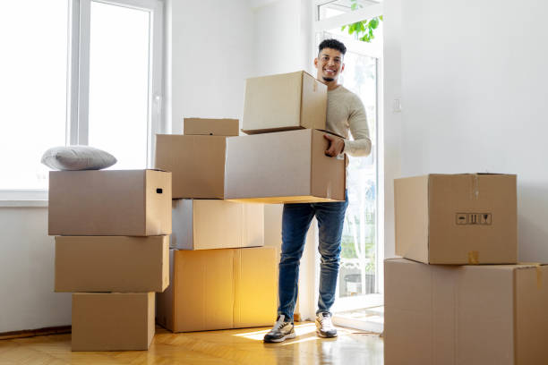 istock Man carrying boxes into his new home 1450404471