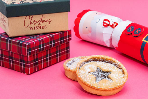 Christmas items scene with two mince pies.
