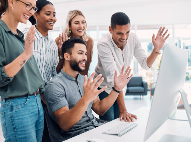 istock Video conference, business and employees with wave while talking on a computer together at work. Happy, corporate and young group of marketing employees greeting on a webinar on a pc in an office 1450405490