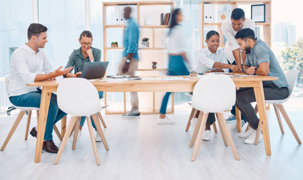 istock Busy, office and employees working in collaboration, meeting and talking about corporate work. Fast, professional and coworking business space for marketing team at a startup company with diversity 1450405618
