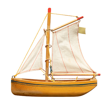a vintage wooden toy sailboat on white with clipping path