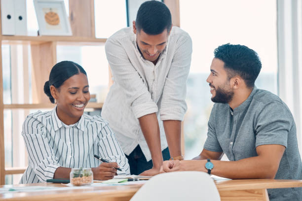 istock Strategy, teamwork and young business people in a meeting in creative workspace. Diversity, working and happy team brainstorming ideas, design and planning for startup company in business meeting 1450406485