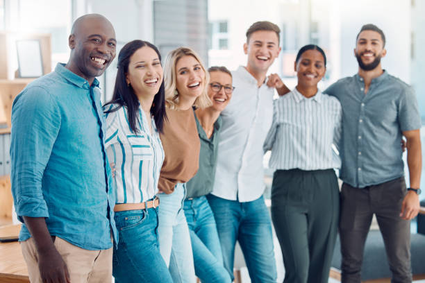 istock Corporate, happy and business people with smile while working together in an office at work. Portrait of diversity, motivation and comic employees in collaboration as a team at a marketing company 1450406581