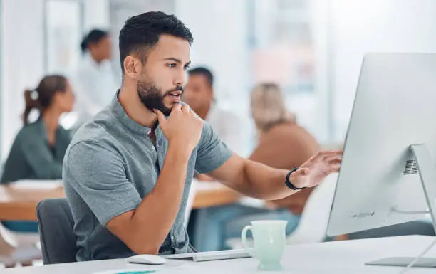 Photo of Startup, office and man at desk with computer working on creative project for marketing or advertising business. Businessman, graphic designer or software developer working on digital transformation.