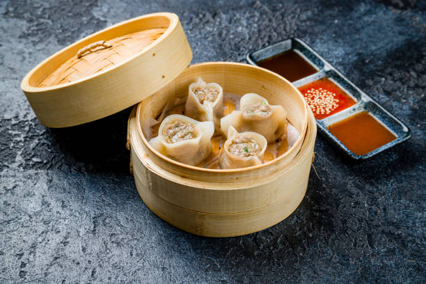 istock dim sum with lamb with sauces on dark stone table 1450407470