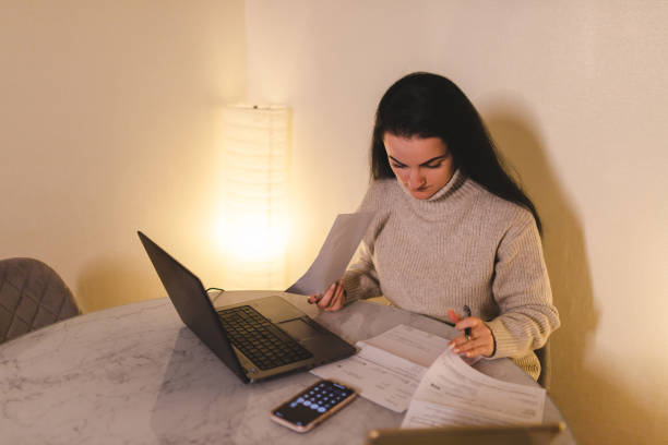 istock Woman paying her bills online at home 1450410856