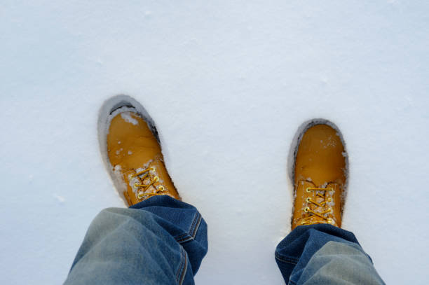 istock Top view of yellow boots in fresh snow 1450411905