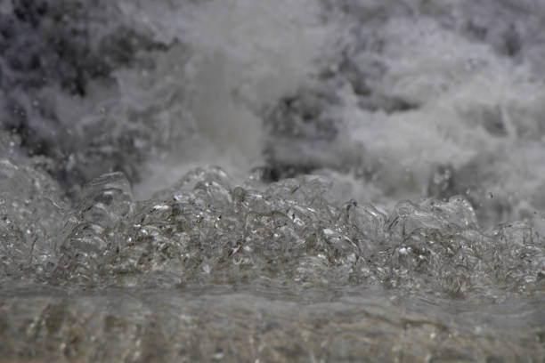 istock water flowing over rocks on a river 1450412509