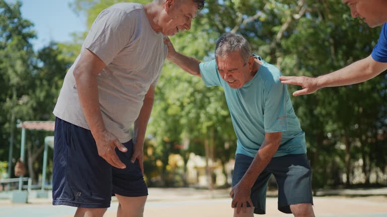 Senior man having leg pain at the basketball court