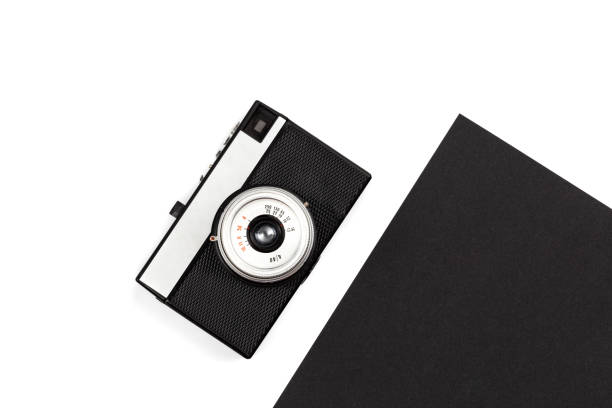 istock Old film camera on a black and white background, flat lay. 1450418780