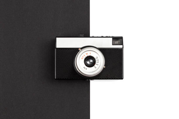 istock Old film camera on a black and white background, flat lay. 1450418787