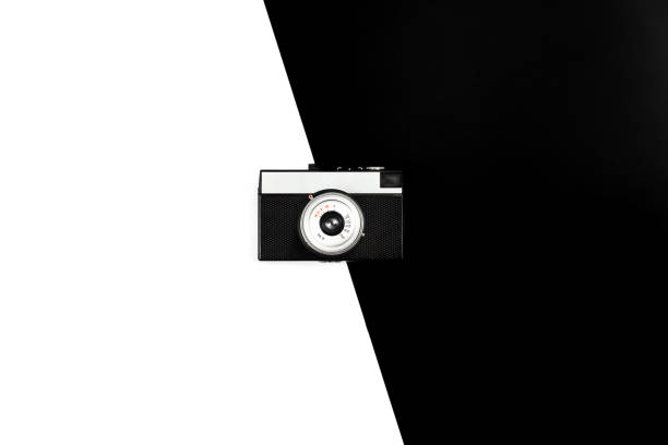 istock Old film camera on a black and white background, flat lay. 1450418790