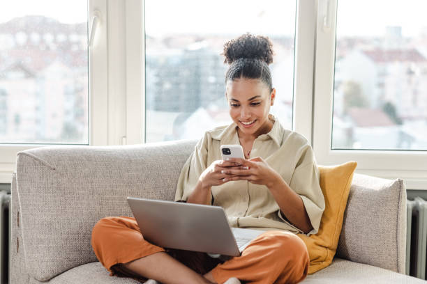 istock Beautiful woman working on a laptop and using smart phone 1450419377