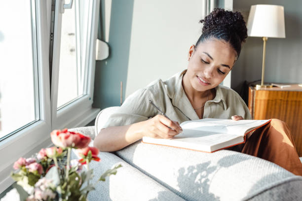 istock Young African American woman writing notes 1450419587