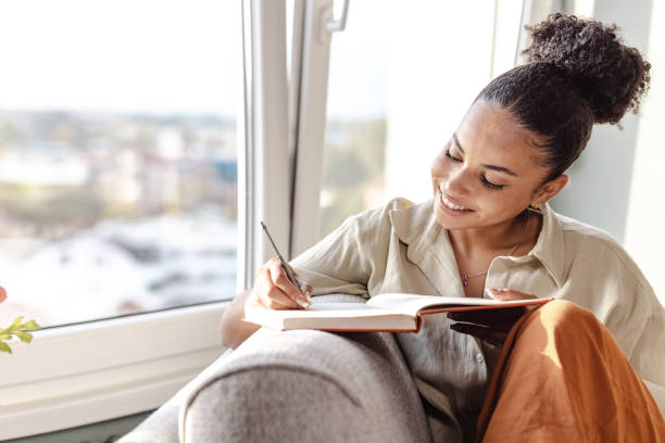 istock Young African American woman writing notes 1450422185