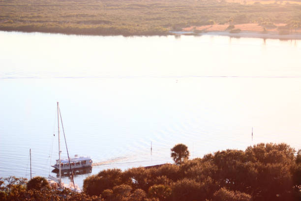 istock Florida inlet at sunset with boat 1450422252