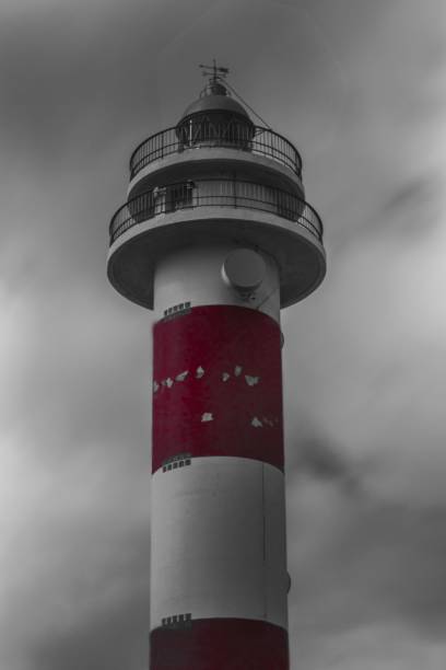 istock Vertical shot of a lighthouse against the dark clouds 1450424825