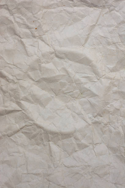 istock Vertical background from old crumpled paper, with a circle squeezed out in the middle. 1450434453