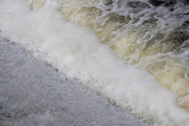 istock water flowing over a dam on a river 1450434979