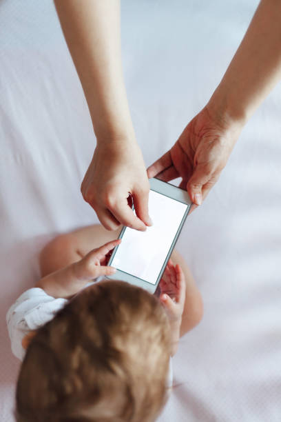 istock Baby and mom using mobile phone 1450434982