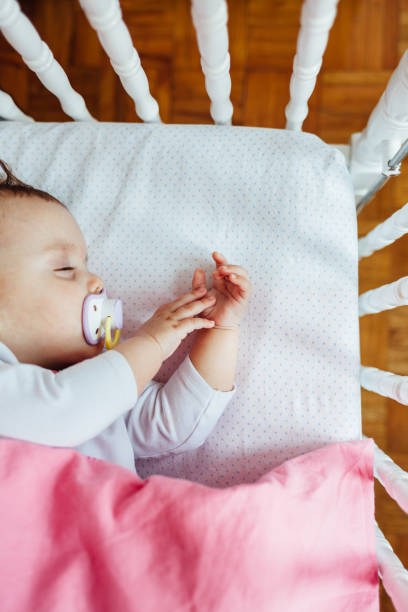 istock Baby girl sleeping in his bed 1450435038