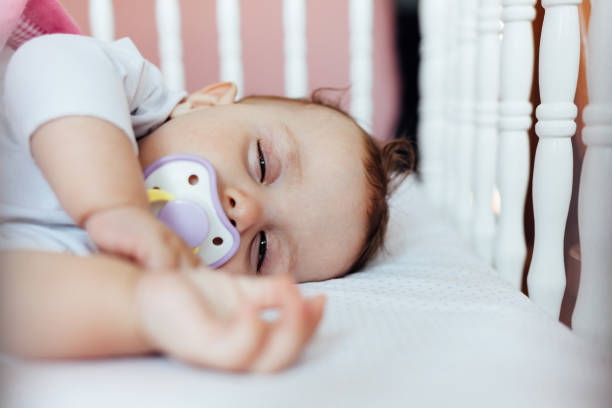 istock Baby girl sleeping in his bed 1450435053