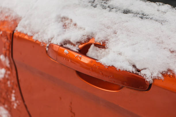 traffic cone being damaged by snow plow in snow