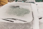 Car window close-up. Car under snow.